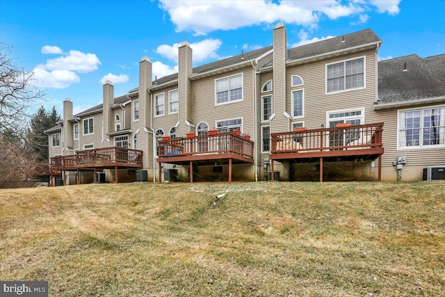 rear view of house featuring central AC, a lawn, and a wooden deck