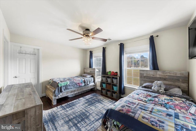 bedroom with ceiling fan and dark hardwood / wood-style floors