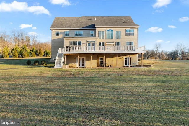 back of house featuring french doors, a deck, and a lawn