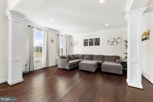 living room with decorative columns, crown molding, and dark hardwood / wood-style floors