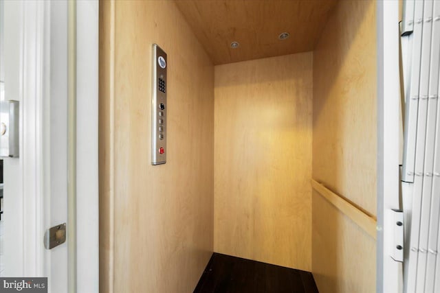 interior space featuring wood ceiling and elevator