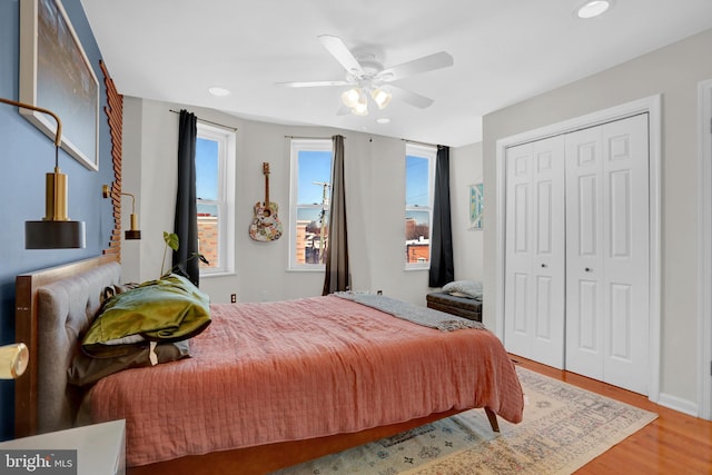 bedroom featuring ceiling fan, hardwood / wood-style floors, and a closet