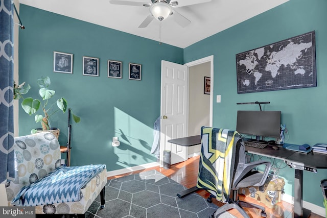 home office featuring hardwood / wood-style floors and ceiling fan