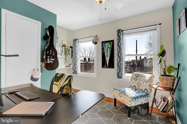 home office with dark hardwood / wood-style flooring and ceiling fan