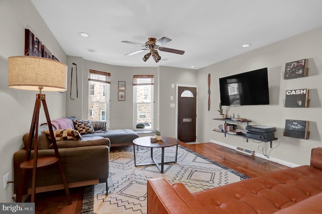 living room with ceiling fan and hardwood / wood-style floors