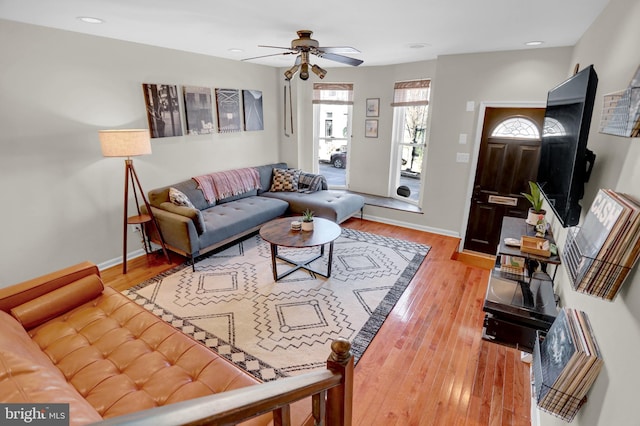 living room with hardwood / wood-style flooring and ceiling fan