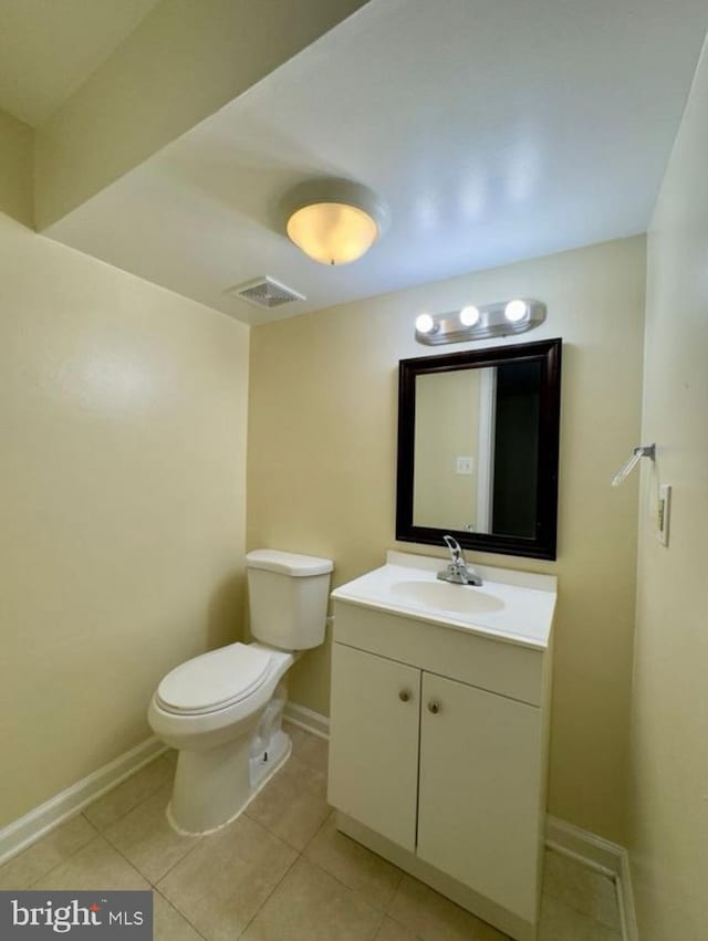 bathroom with vanity, tile patterned floors, and toilet