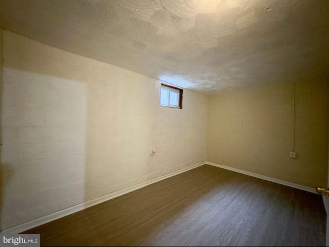 basement featuring dark hardwood / wood-style floors