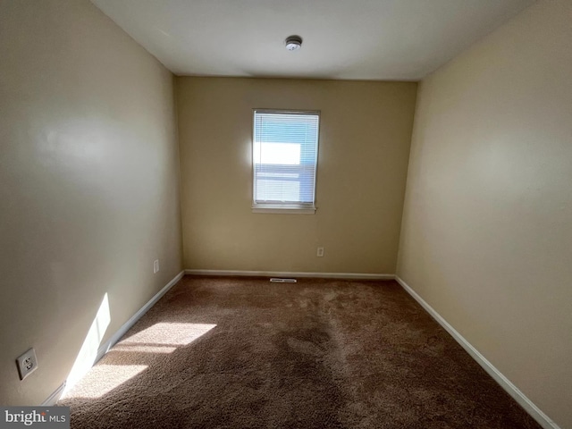 unfurnished room with carpet floors and baseboards