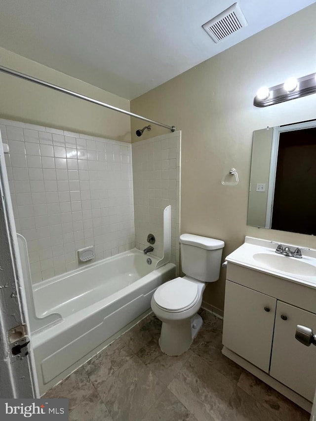 bathroom with bathtub / shower combination, toilet, vanity, visible vents, and baseboards