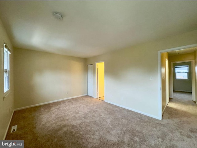 spare room with light carpet