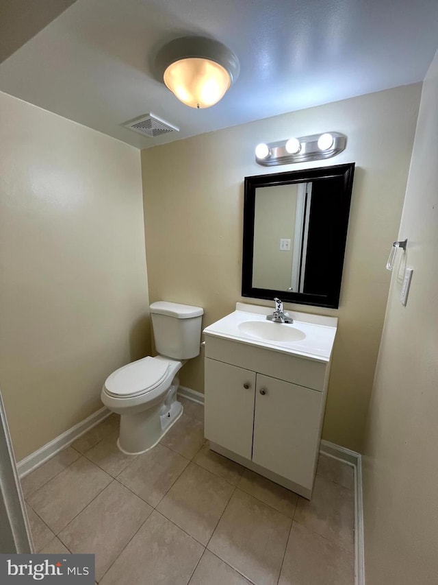 half bath featuring baseboards, visible vents, toilet, tile patterned floors, and vanity