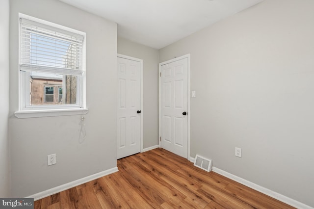 spare room featuring light hardwood / wood-style flooring