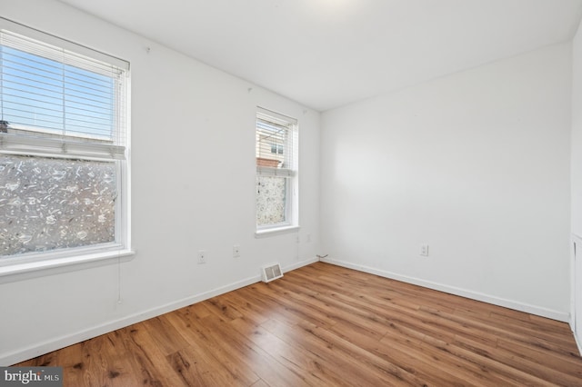 unfurnished room featuring hardwood / wood-style flooring