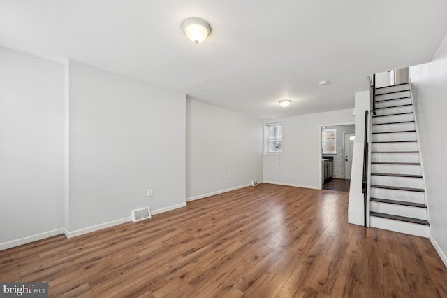 unfurnished living room featuring dark hardwood / wood-style flooring