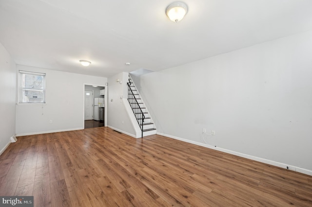 basement with hardwood / wood-style flooring