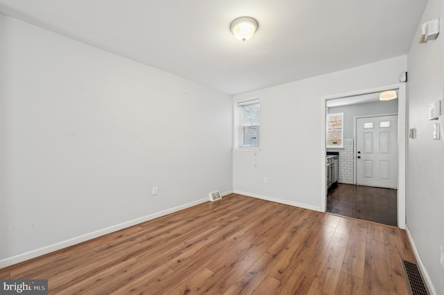 spare room featuring dark hardwood / wood-style floors