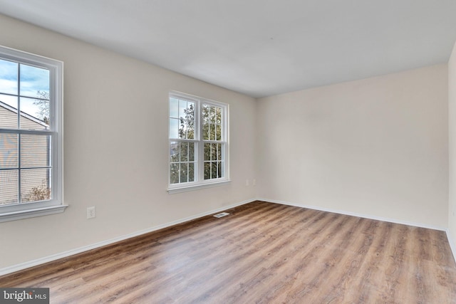 unfurnished room with light wood-type flooring