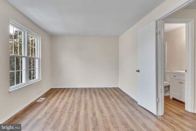 spare room featuring light hardwood / wood-style floors