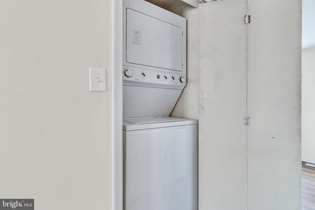 laundry room featuring stacked washer / drying machine