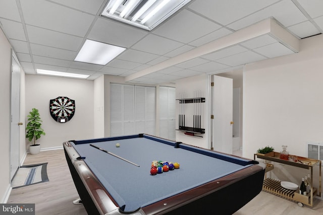 rec room with pool table, a drop ceiling, and light hardwood / wood-style flooring