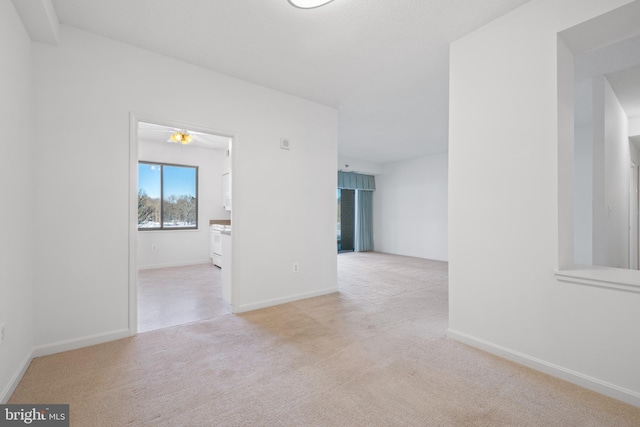 unfurnished room with light colored carpet