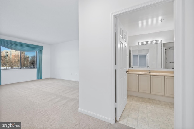 interior space featuring light carpet and sink