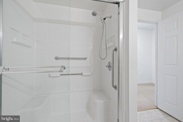 bathroom featuring a shower with shower door