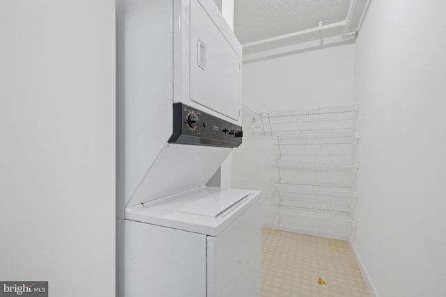 laundry room with stacked washer / dryer