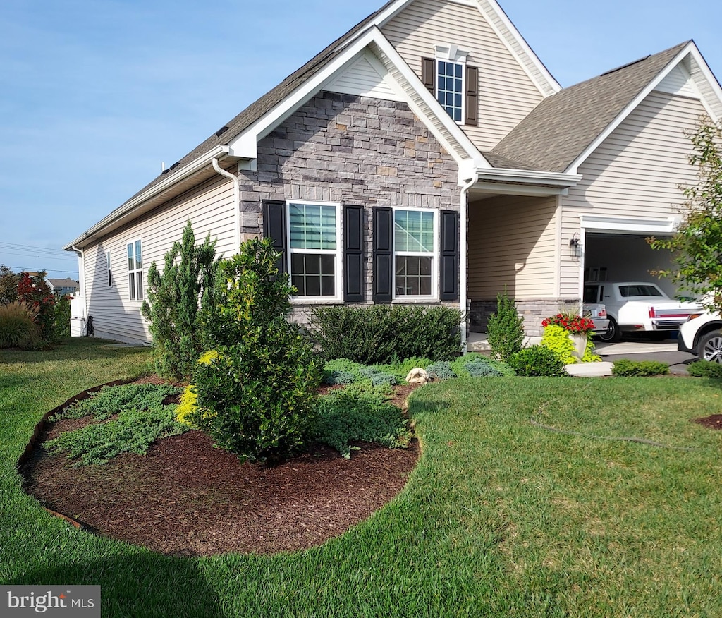 view of front of home with a garage and a front lawn