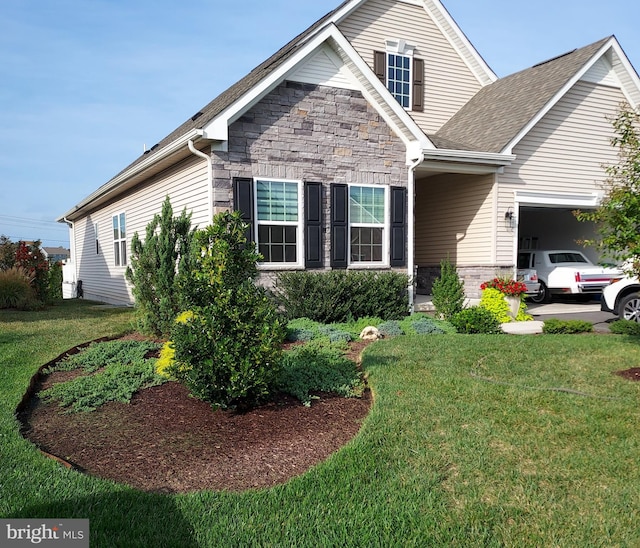 view of front of home with a garage and a front lawn