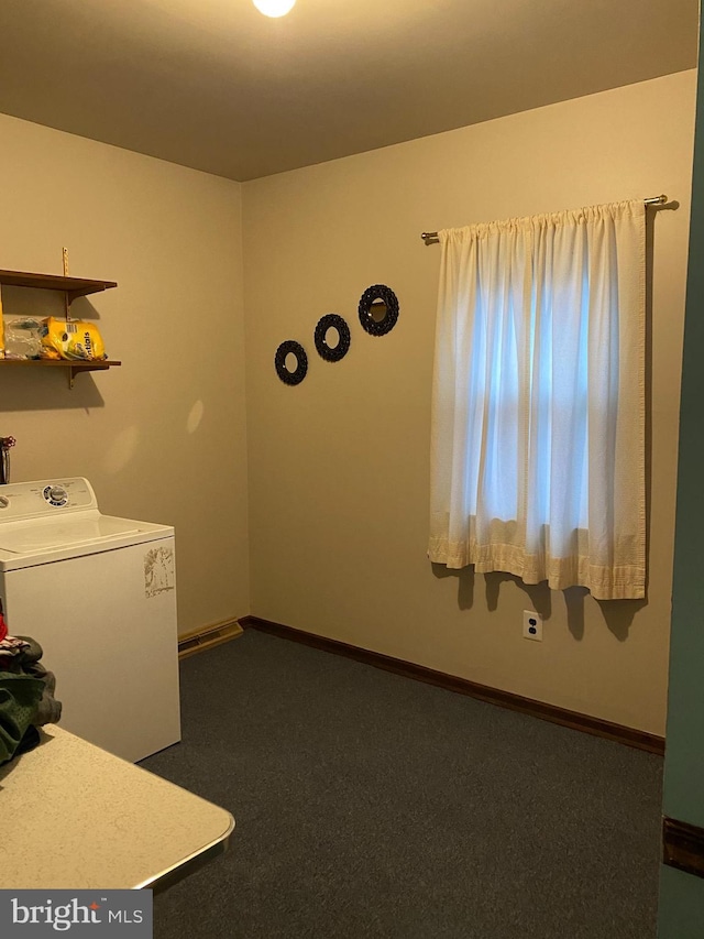 clothes washing area featuring dark carpet and washer / dryer