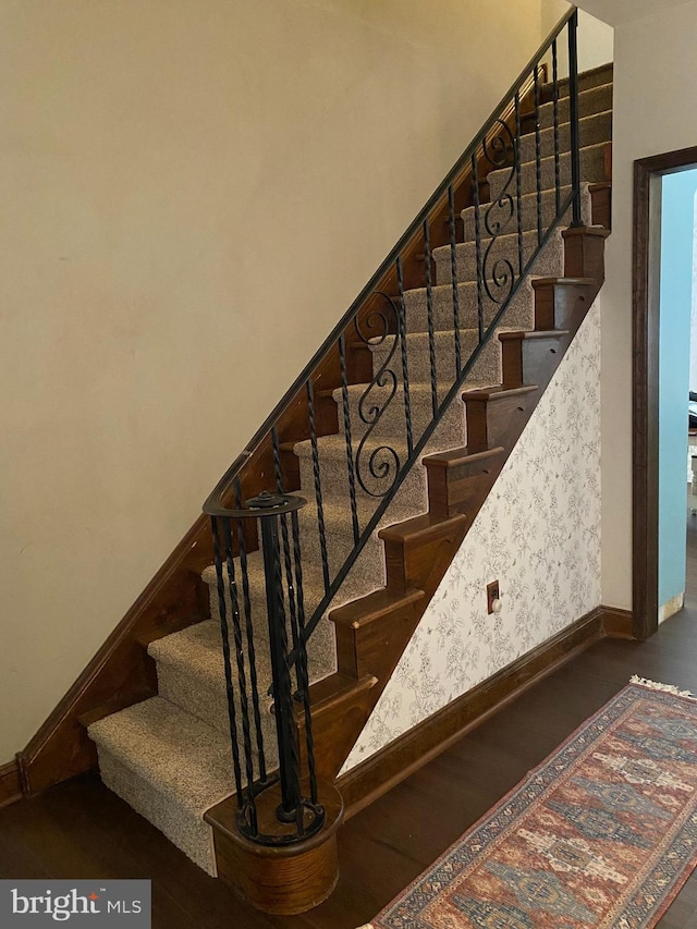 staircase with wood-type flooring