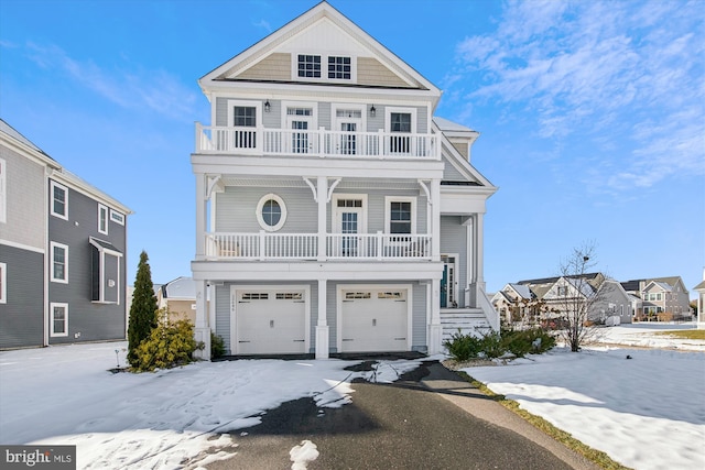 view of front of home with a balcony and a garage