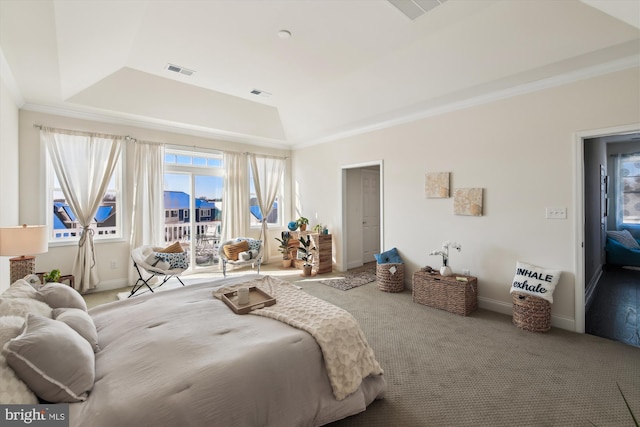 carpeted bedroom featuring a tray ceiling and crown molding