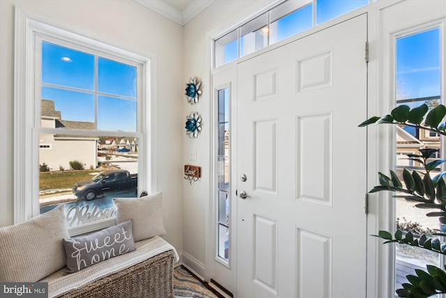 foyer entrance featuring crown molding