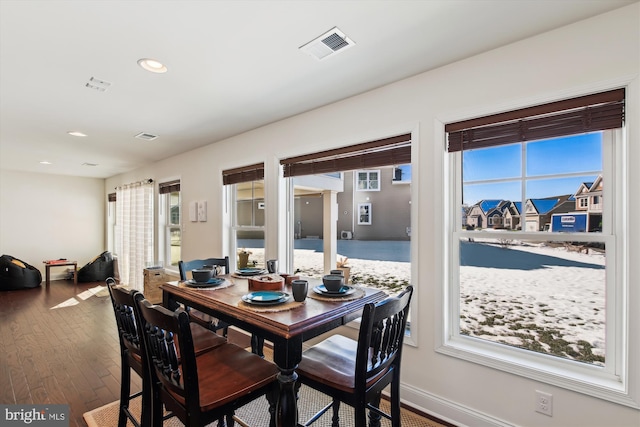 dining area with dark hardwood / wood-style floors