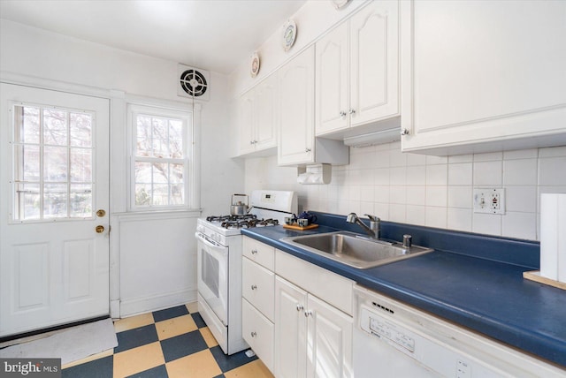 kitchen with white cabinetry, sink, white appliances, and backsplash