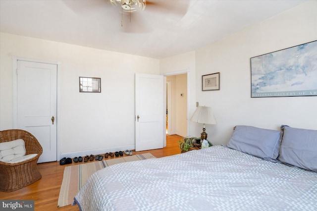 bedroom with ceiling fan and light hardwood / wood-style flooring