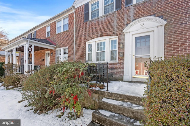 view of snow covered property entrance