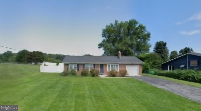 ranch-style home featuring a garage and a front lawn