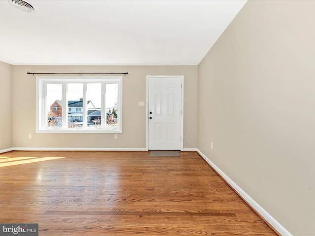 unfurnished room with hardwood / wood-style floors