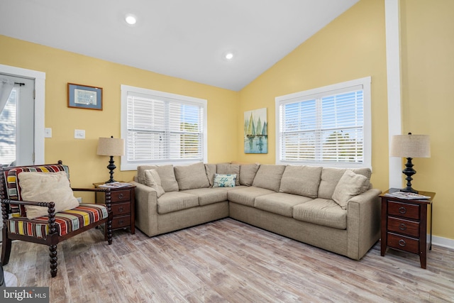 living room with lofted ceiling and light wood-type flooring