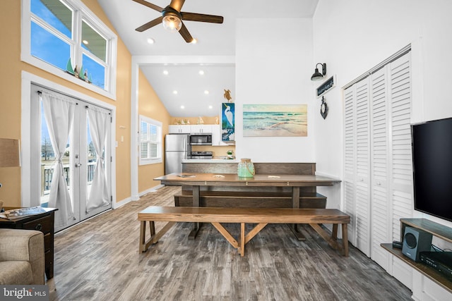 dining room with french doors, ceiling fan, high vaulted ceiling, and hardwood / wood-style floors