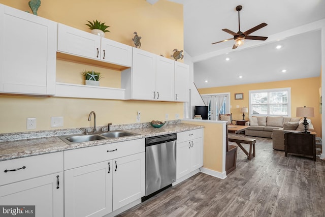 kitchen with sink, white cabinetry, lofted ceiling with beams, stainless steel dishwasher, and hardwood / wood-style floors