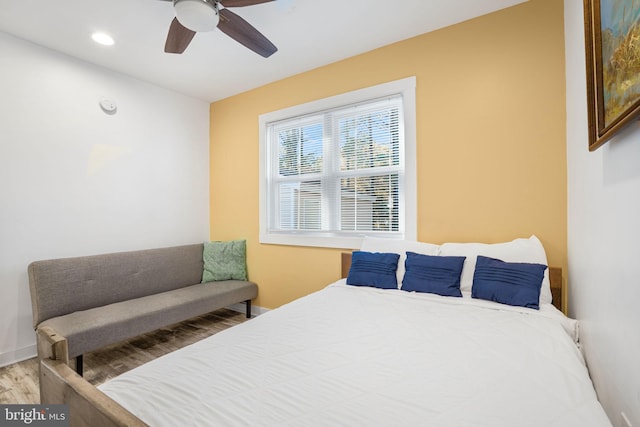 bedroom with wood-type flooring and ceiling fan