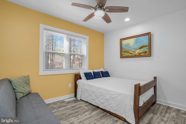 bedroom featuring hardwood / wood-style flooring and ceiling fan