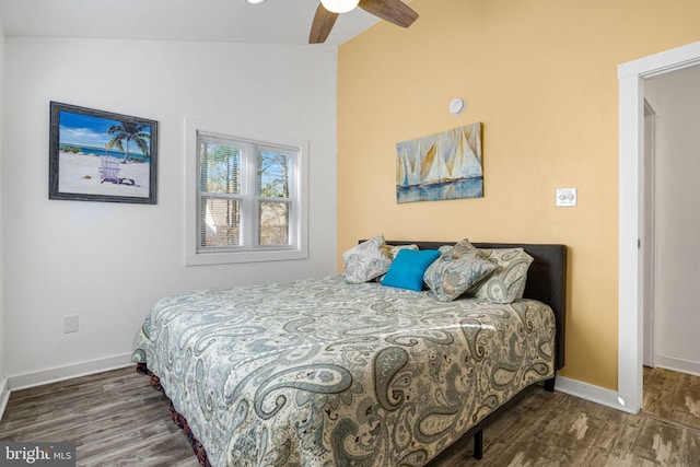 bedroom featuring vaulted ceiling, dark wood-type flooring, and ceiling fan