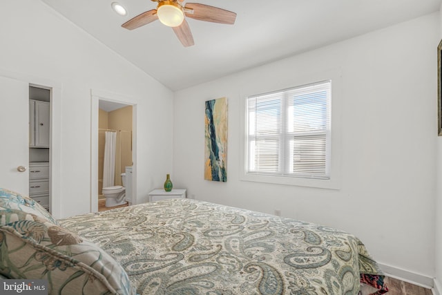 bedroom with vaulted ceiling, ensuite bathroom, and ceiling fan