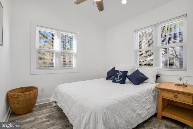 bedroom with dark wood-type flooring, ceiling fan, and vaulted ceiling